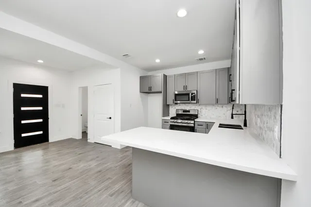 a kitchen with wooden cabinets and white appliances