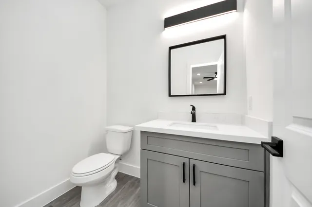 a bathroom with a toilet sink and mirror