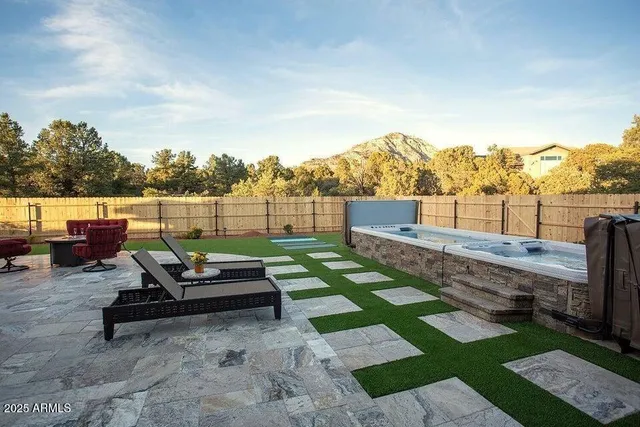 a large bathroom with a granite countertop sink a mirror and a bathtub