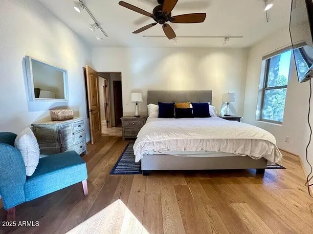 a bedroom with furniture and wooden floor