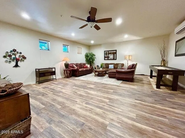 a bathroom with a granite countertop toilet a sink and a mirror