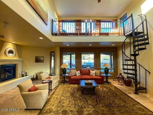 a living room with furniture a window and a fireplace