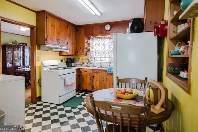 a view of a hallway with furniture and windows