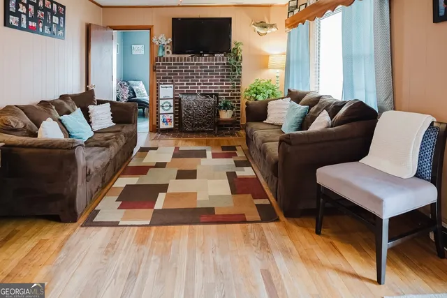 a living room with furniture and a fireplace