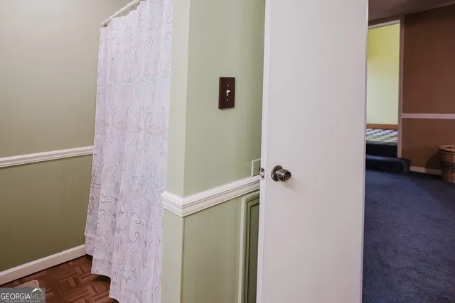 a room with a baby crib and a dresser