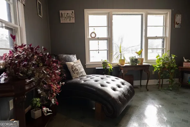 a bed sitting in a bedroom next to a window