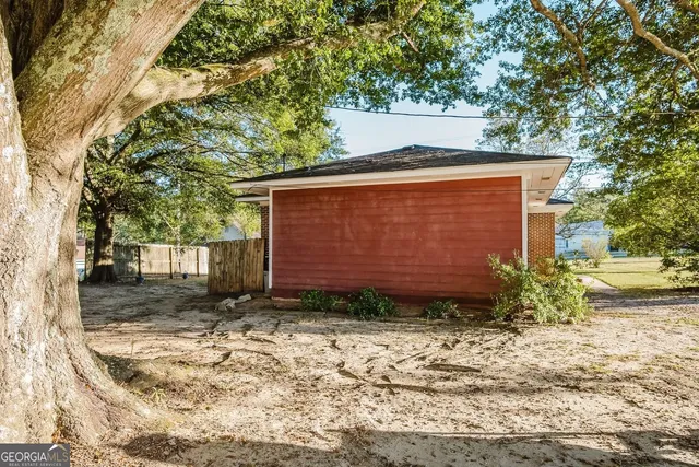 a view of a house with backyard porch and sitting area