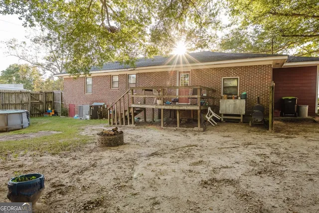 a view of a small house with backyard
