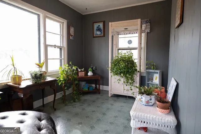 a living room with furniture and flowers