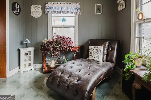 a living room with furniture and flowers