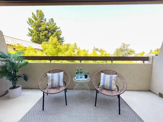 a view of sitting area in balcony with wooden floor