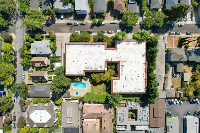 an aerial view of multiple houses with yard