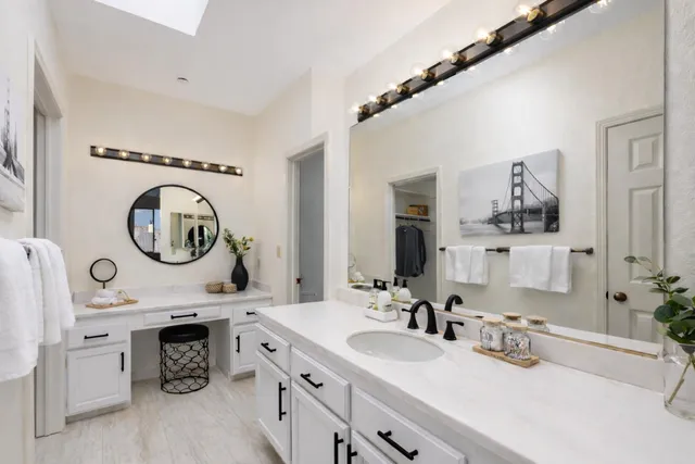 a bathroom with a double vanity sink and a mirror