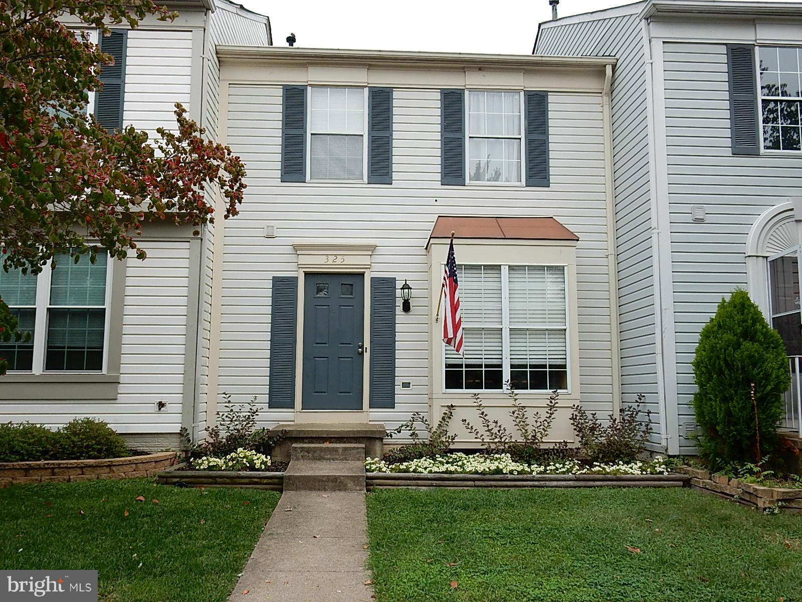 325 Millbrook Terrace Leesburg, VA 20176 - Photo 2 of 20 a front view of a house with a garden and plants
