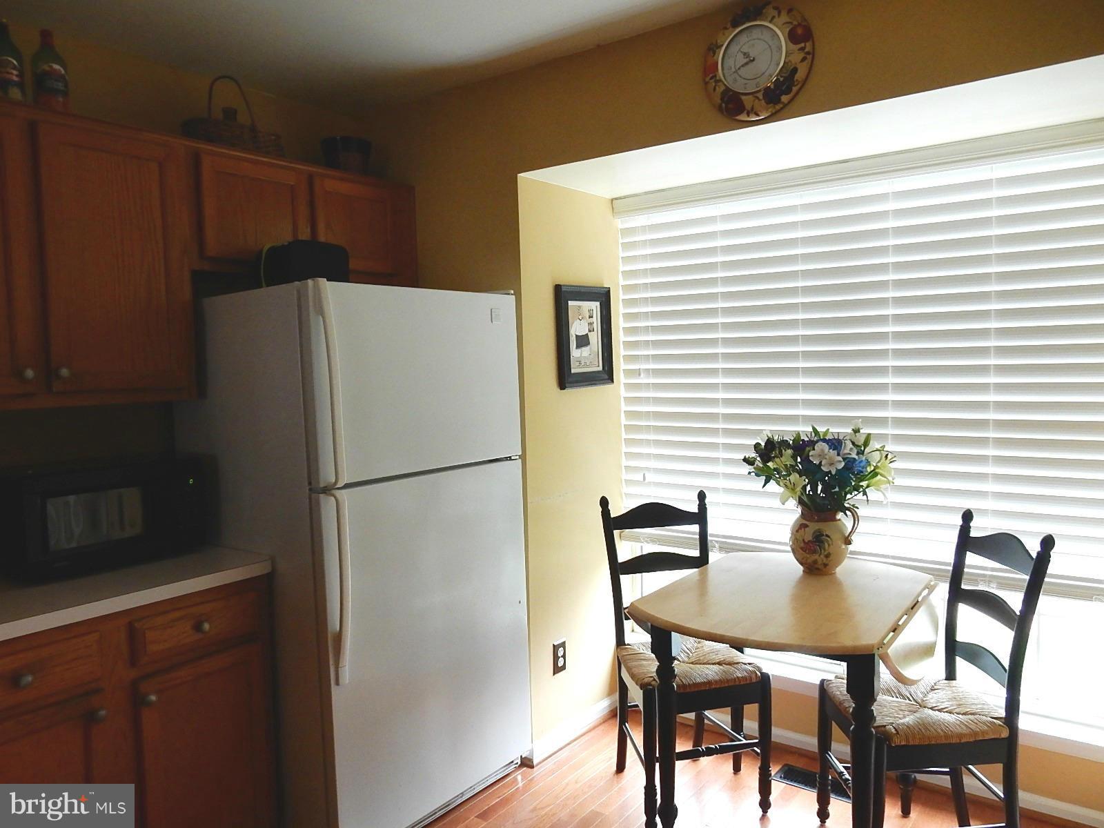 325 Millbrook Terrace Leesburg, VA 20176 - Photo 5 of 20 a white table and chairs in a kitchen