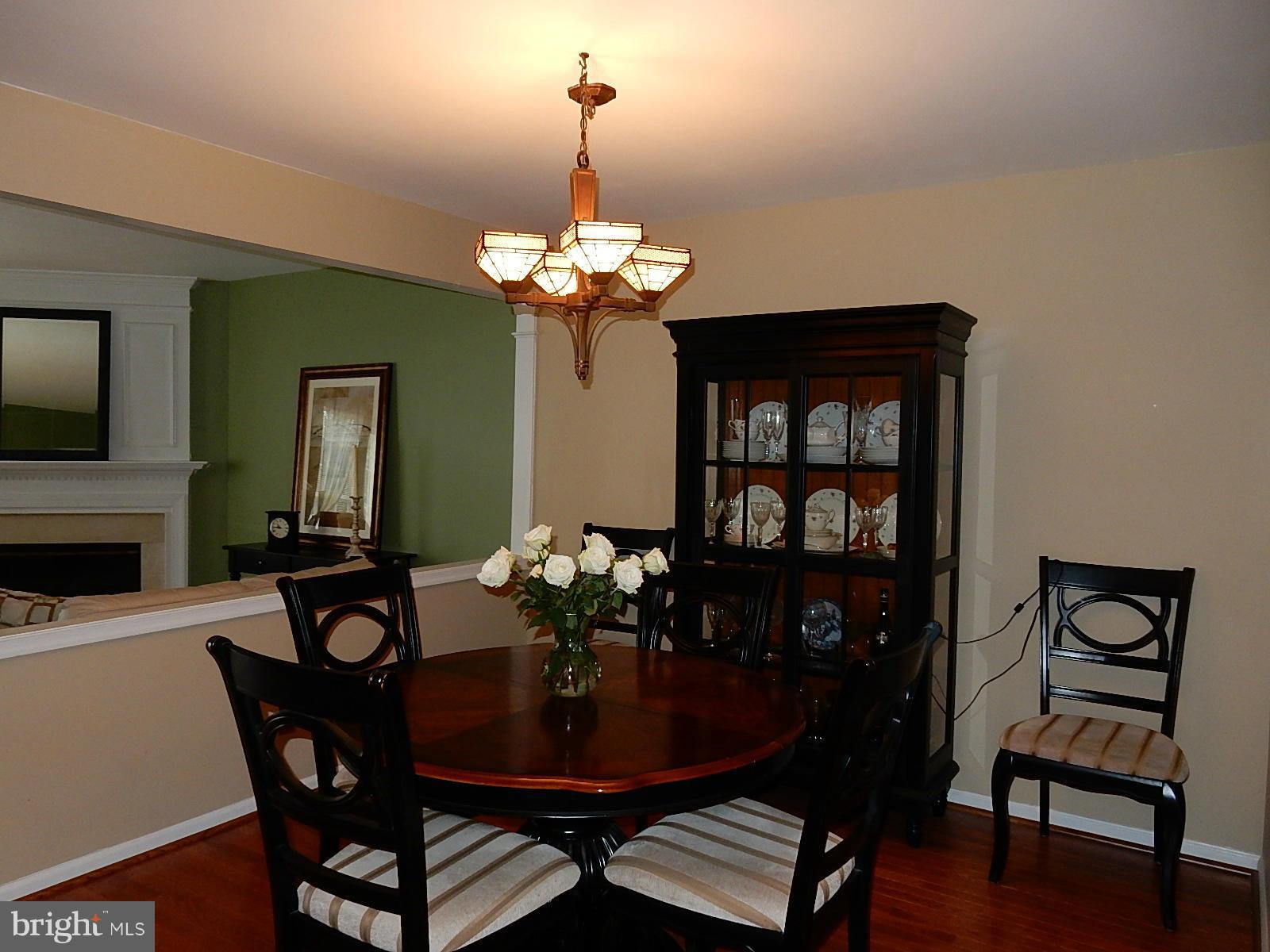 325 Millbrook Terrace Leesburg, VA 20176 - Photo 6 of 20 a view of a dining room with furniture wooden floor and chandelier