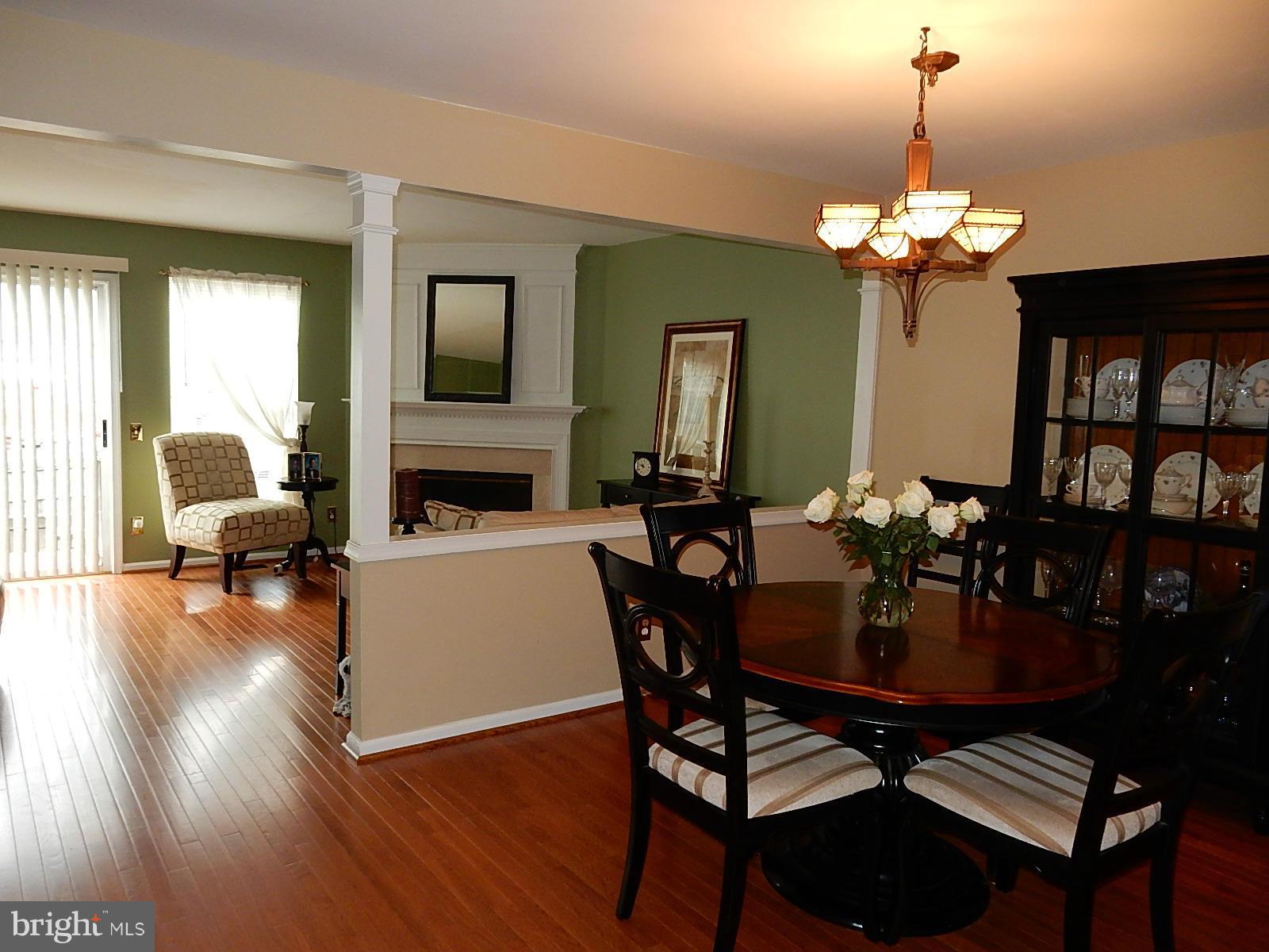 325 Millbrook Terrace Leesburg, VA 20176 - Photo 9 of 20 a view of a dining room with furniture a chandelier and wooden floor