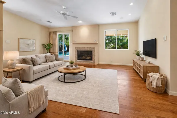 a living room with furniture flat screen tv and a fireplace