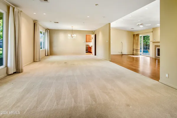 a view of empty room with wooden floor and windows