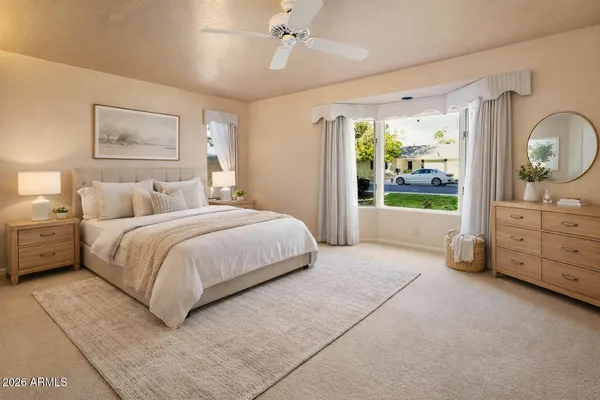 a bedroom with a large bed and a dresser