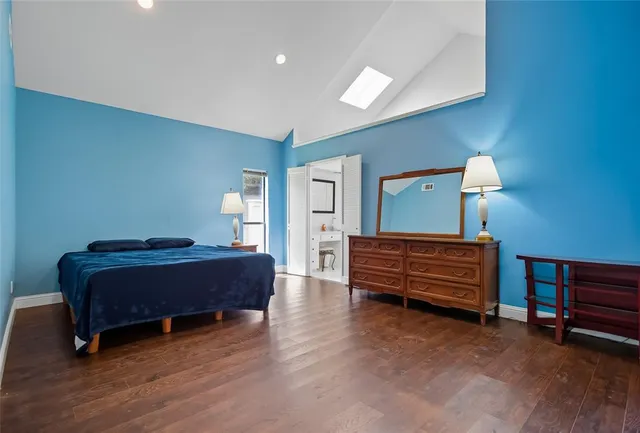 a bedroom with furniture and a lamp