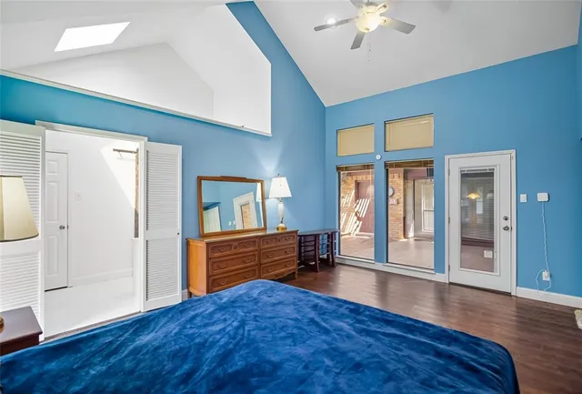 a view of an livingroom with wooden floor and a ceiling fan