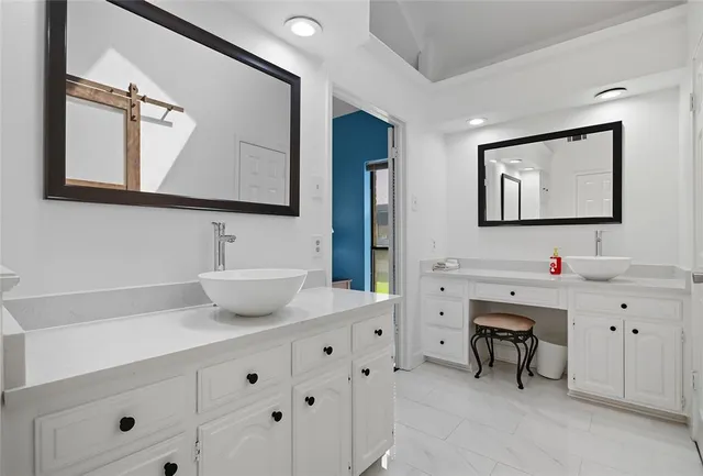 a bathroom with a double vanity sink and a mirror