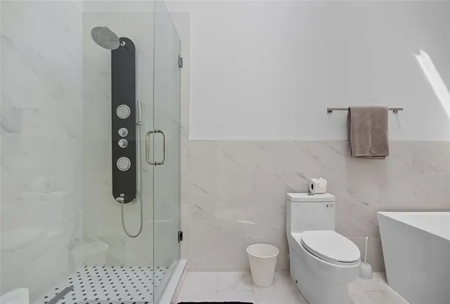 a bathroom with a toilet sink and shower