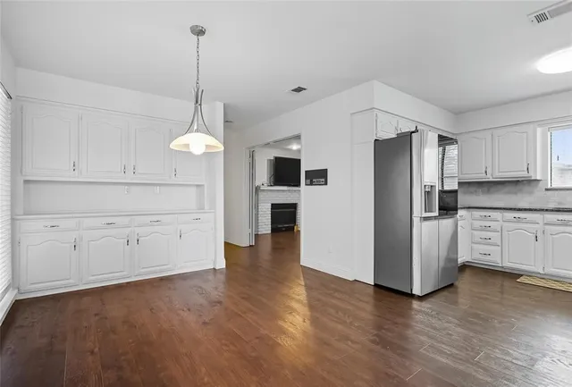a kitchen with stainless steel appliances a refrigerator sink and cabinets