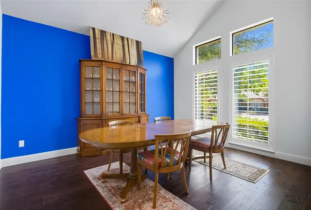 a view of a dining room with furniture and chandelier