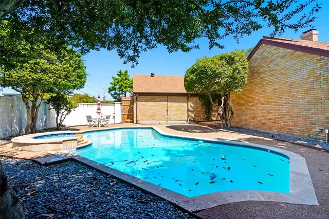 a view of a swimming pool with a yard