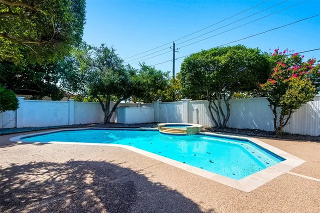 a view of a backyard with a small pool and plants
