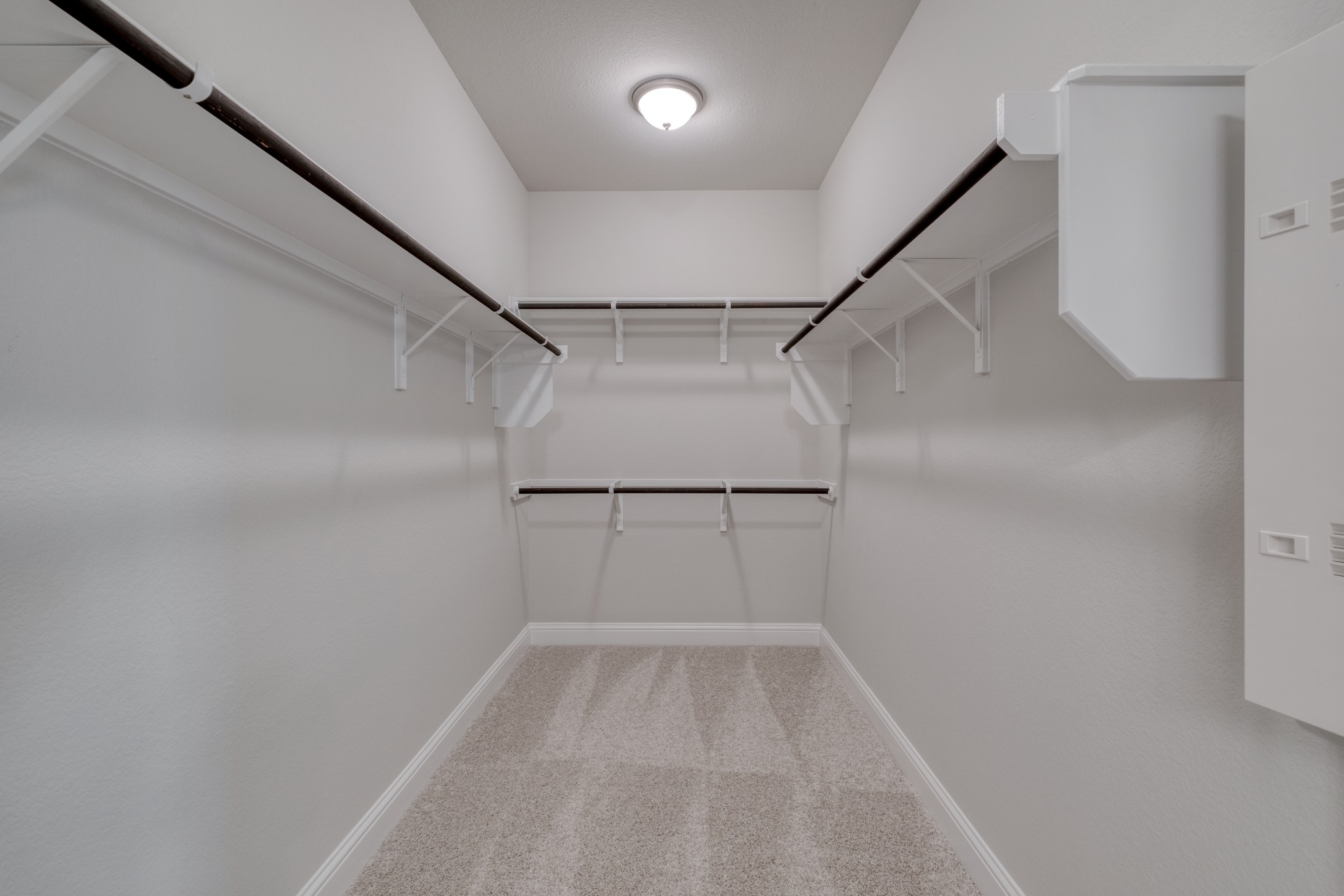 2605 Sam Bass Road, Unit 44 Round Rock, TX 78681 - Photo 19 of 26 Ample hanging space and shelving await in this well-appointed, carpeted walk-in closet.