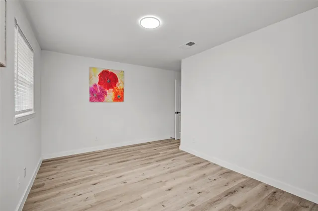 an empty room with wooden floor