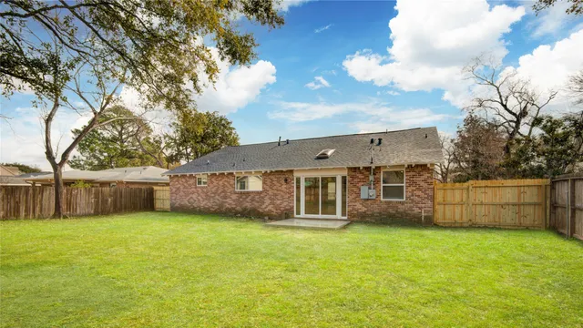 a view of a house with a yard and sitting area