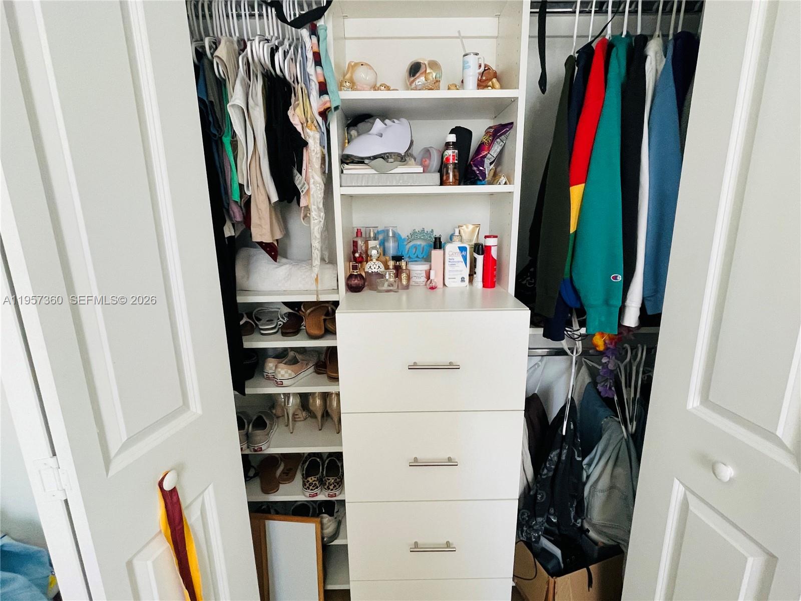 23153 Southwest 128th Place Miami, FL 33177 - Photo 14 of 22 a view of walk in closet with clothes and shoes
