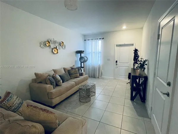 a living room with furniture and a chandelier