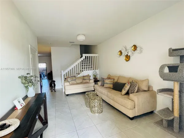 a living room with furniture and a chair