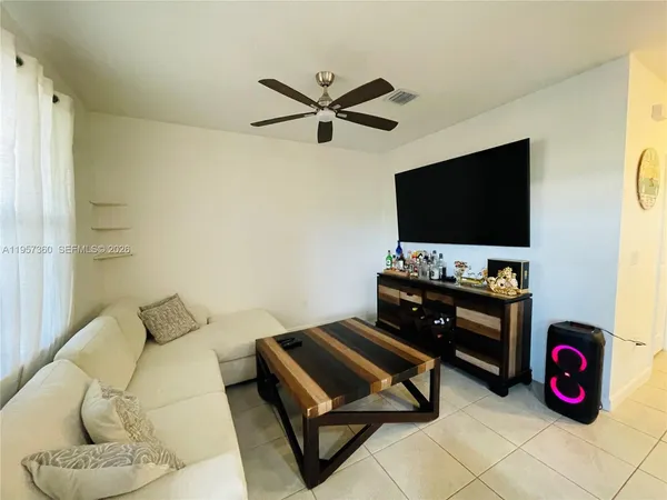 a living room with furniture and a flat screen tv