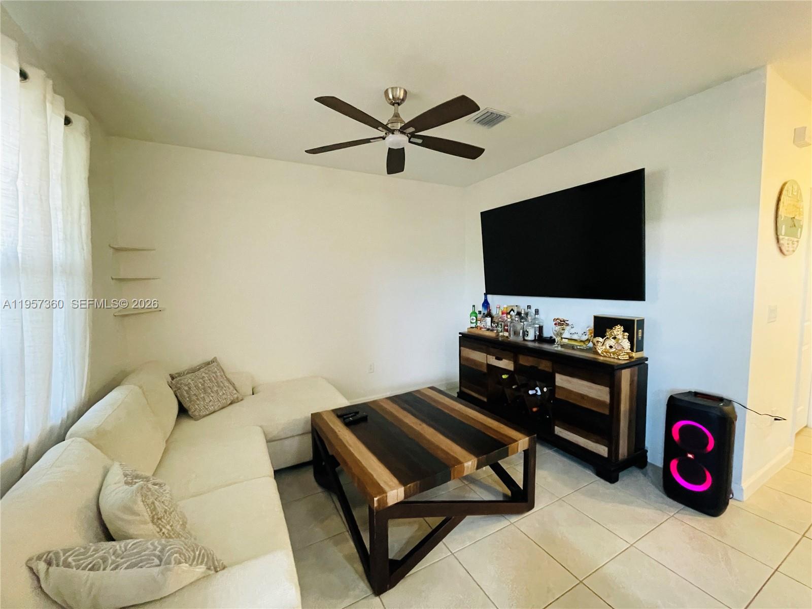 23153 Southwest 128th Place Miami, FL 33177 - Photo 6 of 22 a living room with furniture and a flat screen tv