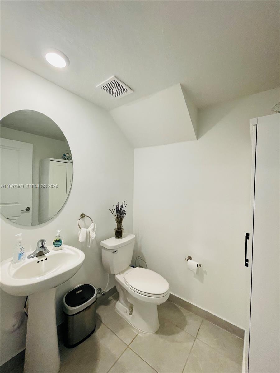 23153 Southwest 128th Place Miami, FL 33177 - Photo 9 of 22 a bathroom with a toilet sink and mirror