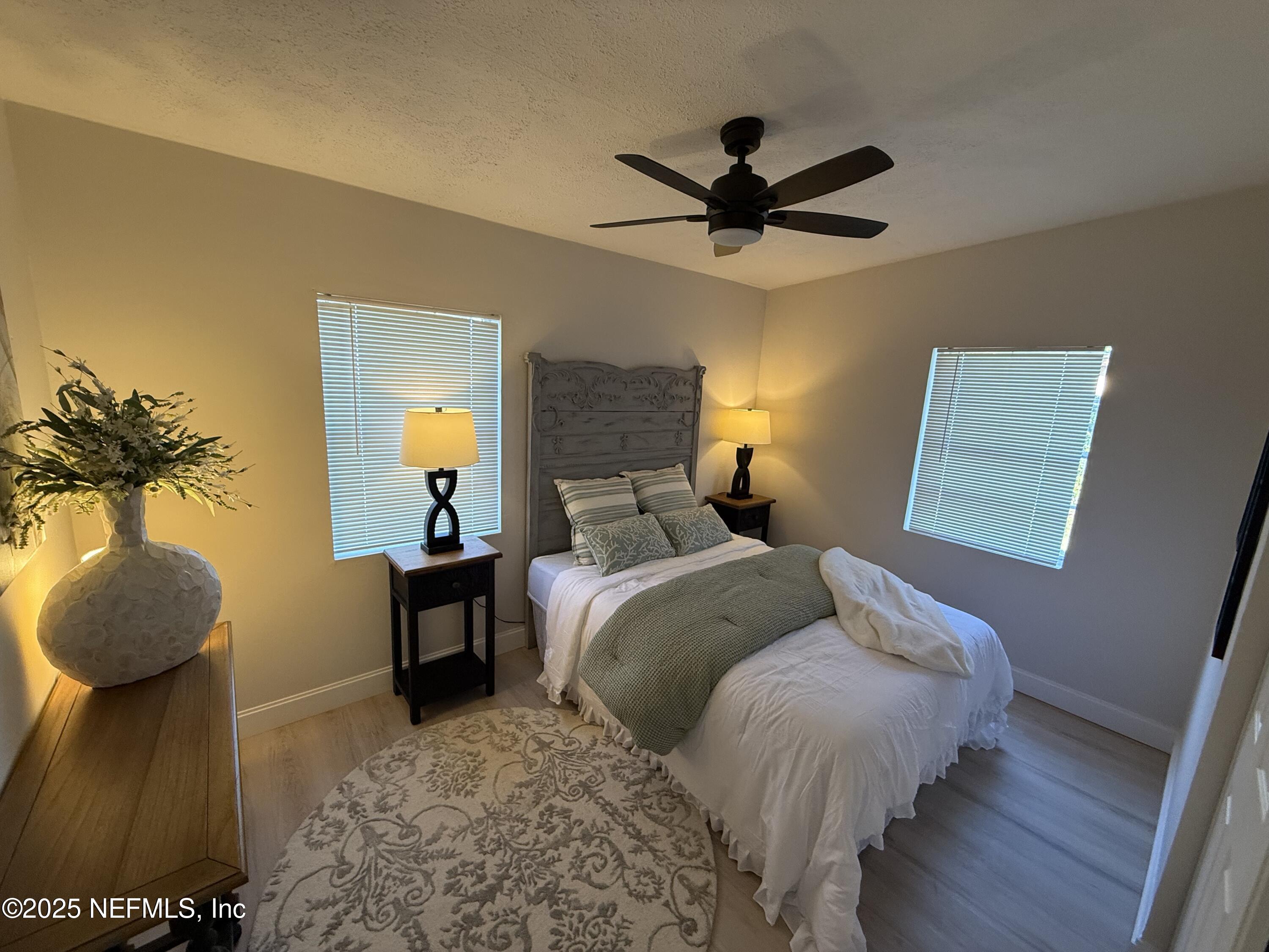 10563 Arendal Road Jacksonville, FL 32218 - Photo 6 of 11 a bedroom with a bed and a chandelier