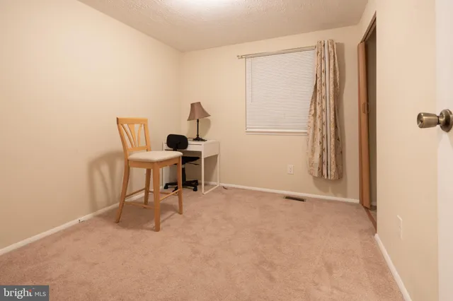 a work room with furniture and a window