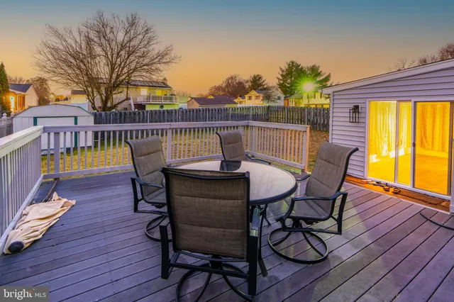 a view of a roof deck with table and chairs