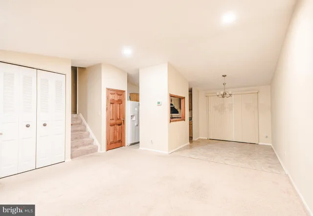 a view of a big room with closet and windows