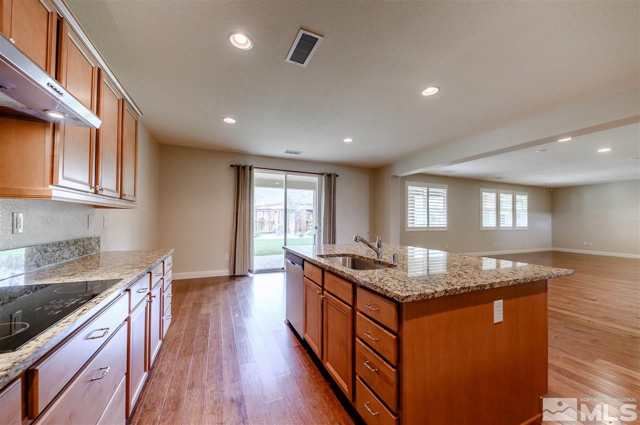 9880 Kerrydale Court Reno, NV 89521 - Photo 4 of 20 a kitchen with granite countertop stove top oven and cabinets