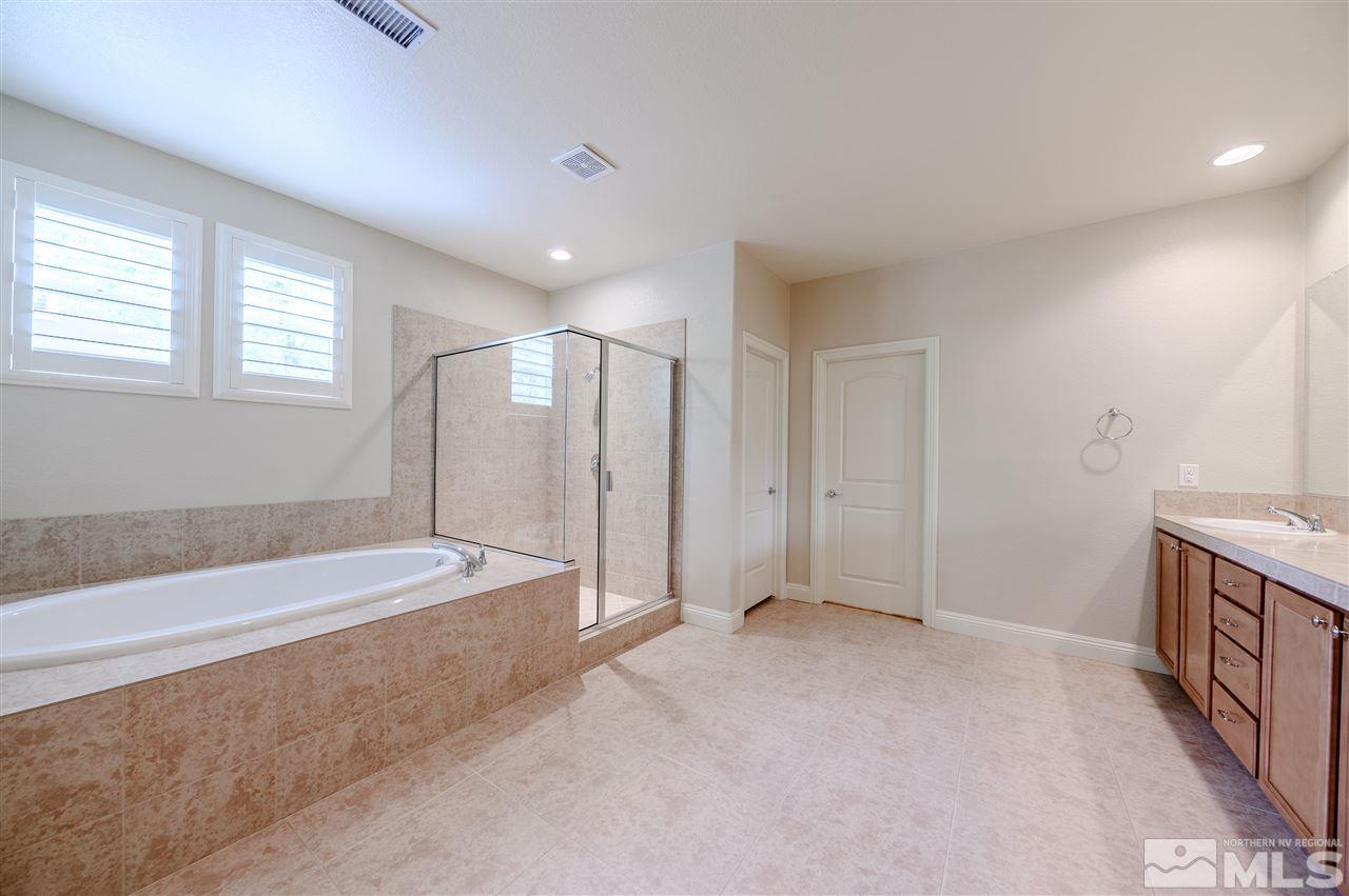 9880 Kerrydale Court Reno, NV 89521 - Photo 6 of 20 a spacious bathroom with a large tub shower and checkered floor
