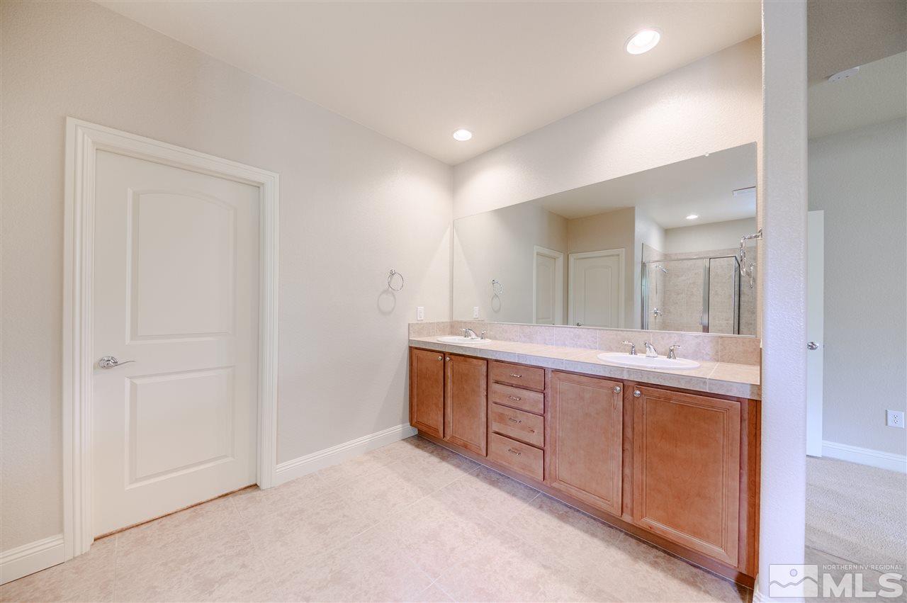 9880 Kerrydale Court Reno, NV 89521 - Photo 7 of 20 a spacious bathroom with a double vanity sink and mirror