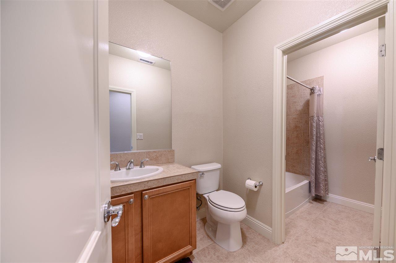 9880 Kerrydale Court Reno, NV 89521 - Photo 10 of 20 a bathroom with a granite countertop sink toilet and shower