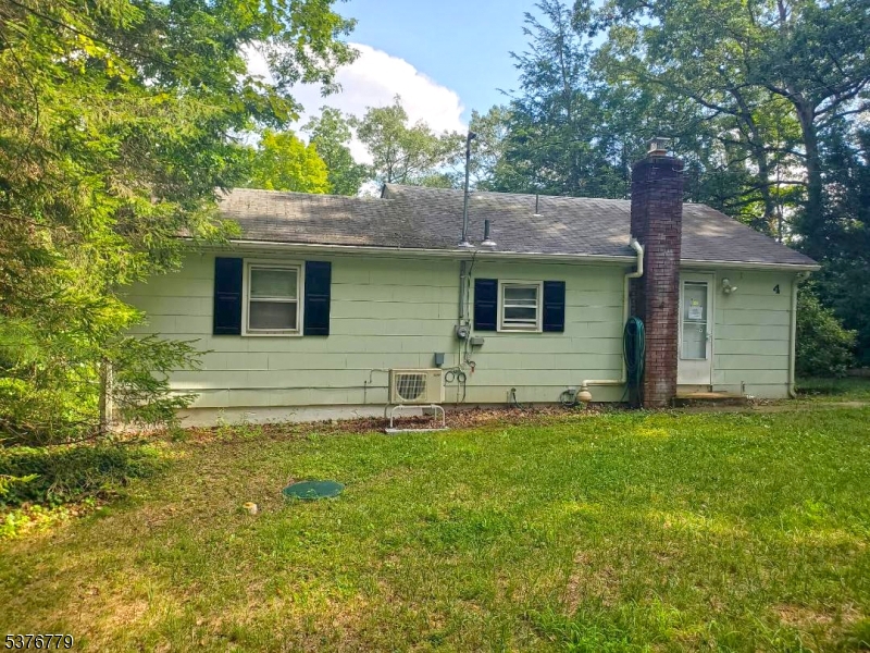 4 Village Place Oak Ridge, NJ 07438 - Photo 1 of 15 a front view of a house with a garden